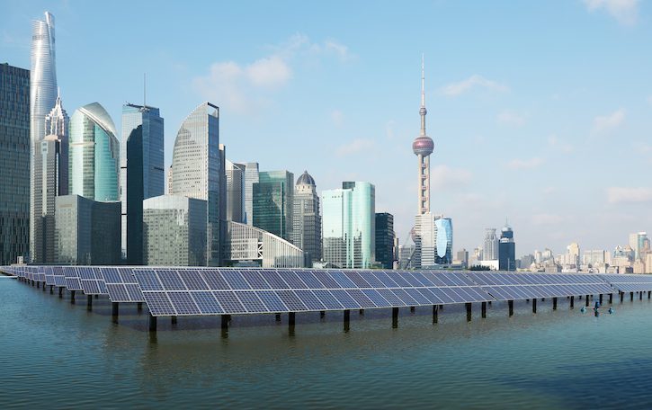 Eco-environmentally friendly green energy of sustainable development of solar power plant with Shanghai skyline